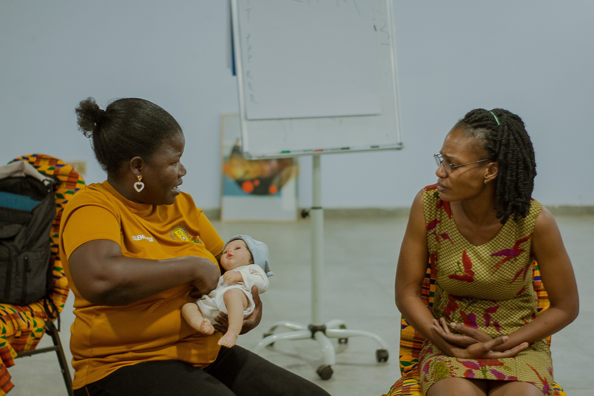 Participants practice newborn nursing techniques.